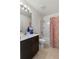 Clean bathroom with a white shower-tub, a vanity with a sink and tile flooring at 1924 Amber Sweet Cir, Dundee, FL 33838