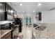 Well-equipped kitchen with dark cabinets, granite countertops, and modern appliances at 1924 Amber Sweet Cir, Dundee, FL 33838
