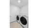 Clean laundry room features Samsung washer and dryer, a white door, and neutral tile floors at 1924 Amber Sweet Cir, Dundee, FL 33838