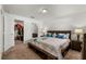 Spacious main bedroom with a view of the closet, bedside lamps and a double bed at 1924 Amber Sweet Cir, Dundee, FL 33838