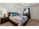 Comfortable main bedroom featuring a large bed, side tables, and carpeted floors at 1924 Amber Sweet Cir, Dundee, FL 33838
