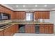 Kitchen boasts granite counters, dark wood cabinets, and double ovens at 196 Paradise Island Dr, Haines City, FL 33844