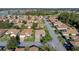 Single-story house on a tree-lined street, aerial view at 4076 Tralee Dr, Lake Wales, FL 33859