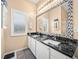 Bathroom with double vanity, granite countertop, and large mirror at 4076 Tralee Dr, Lake Wales, FL 33859