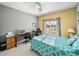 Bedroom with a bed, desk, and window overlooking the backyard at 4076 Tralee Dr, Lake Wales, FL 33859