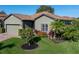 Landscaped home with a two-car garage and lush green lawn at 4076 Tralee Dr, Lake Wales, FL 33859