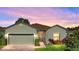 Well-maintained house with a landscaped front yard, neutral color scheme, and a two-car garage at 4076 Tralee Dr, Lake Wales, FL 33859
