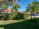 Backyard view with lush landscaping and palm trees at 4076 Tralee Dr, Lake Wales, FL 33859