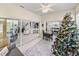 Bright sunroom with view into the living area and kitchen, featuring a Christmas tree at 4076 Tralee Dr, Lake Wales, FL 33859