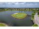 Aerial view of golf course community with lake and homes at 4089 Dunmore Dr, Lake Wales, FL 33859