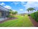 Landscaped backyard with pond and clubhouse views at 4151 Muirfield Loop, Lake Wales, FL 33859