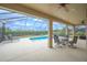 Screened pool and patio area with seating at 4151 Muirfield Loop, Lake Wales, FL 33859