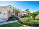 House exterior showcasing a walkway, landscaping, and a two-car garage at 4340 Winding Oaks Cir, Mulberry, FL 33860