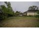 Overgrown backyard with a pool and patio at 6102 N Fork Ct, Lakeland, FL 33809
