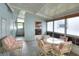 Bright, enclosed porch with seating and large windows at 6308 Bayberry Ne Blvd, Winter Haven, FL 33881