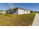 Side yard view showing grassy area and home exterior at 727 Annabell Ridge Rd, Minneola, FL 34715