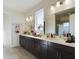 Elegant bathroom with double vanity, large mirror, and walk-in shower at 727 Annabell Ridge Rd, Minneola, FL 34715