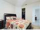 Cozy bedroom with patterned bedding, a large TV, and dark wood furniture at 727 Annabell Ridge Rd, Minneola, FL 34715