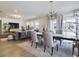 Bright dining room with a large table, six chairs, and a modern chandelier at 727 Annabell Ridge Rd, Minneola, FL 34715