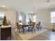 Bright dining room with a large table, six chairs, and a modern chandelier at 727 Annabell Ridge Rd, Minneola, FL 34715