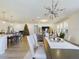 Bright dining room with a large table, six chairs, and a modern chandelier at 727 Annabell Ridge Rd, Minneola, FL 34715