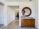 Bright entryway with wood console table and large circular mirror at 727 Annabell Ridge Rd, Minneola, FL 34715