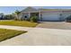 Two-story house with light gray siding, white columns, and a landscaped yard at 727 Annabell Ridge Rd, Minneola, FL 34715