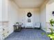 Covered porch with stone accents, two chairs, and a wooden table at 727 Annabell Ridge Rd, Minneola, FL 34715