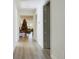 Long hallway with light walls and wood-look flooring, leading to living room at 727 Annabell Ridge Rd, Minneola, FL 34715