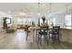 Open concept kitchen boasts white cabinets, large island, and stainless steel appliances at 727 Annabell Ridge Rd, Minneola, FL 34715