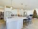 Bright kitchen with white cabinets, large island, and modern finishes at 727 Annabell Ridge Rd, Minneola, FL 34715