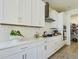 Modern kitchen with white cabinets, quartz countertops, and stainless steel appliances at 727 Annabell Ridge Rd, Minneola, FL 34715