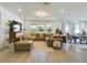 Spacious living room with a large sectional sofa, hardwood floors, and large windows at 727 Annabell Ridge Rd, Minneola, FL 34715
