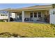 Relaxing covered patio with seating area and potted plants at 727 Annabell Ridge Rd, Minneola, FL 34715