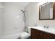 Cozy bathroom featuring tiled shower and vanity with a dark finish at 7968 Apache Ln, Lakeland, FL 33810