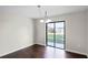 Open dining room with wood floors and a sliding glass door to the backyard at 7968 Apache Ln, Lakeland, FL 33810