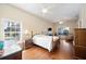 Comfortable bedroom featuring hardwood floors and a ceiling fan at 8460 Plantation Ridge Blvd, Lakeland, FL 33809