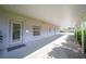 Covered walkway leading to a side entrance of the house with exterior lighting at 8460 Plantation Ridge Blvd, Lakeland, FL 33809