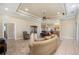 Open living room with a herringbone wood floor, multiple seating areas, and a ceiling fan at 8460 Plantation Ridge Blvd, Lakeland, FL 33809