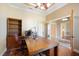 Bright home office featuring a large desk and wood flooring at 8460 Plantation Ridge Blvd, Lakeland, FL 33809