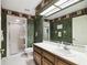 Bathroom with shower, toilet and double sinks at 111 Woden Way, Winter Haven, FL 33884