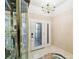 Elegant entryway with tiled floor, glass door, and display cabinet at 111 Woden Way, Winter Haven, FL 33884