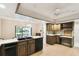 Large kitchen with island, ample counter space, and access to backyard at 111 Woden Way, Winter Haven, FL 33884