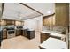 Kitchen with stainless steel appliances and wood cabinetry at 111 Woden Way, Winter Haven, FL 33884