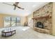 Spacious living room featuring a brick fireplace and large windows at 111 Woden Way, Winter Haven, FL 33884