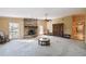 Living room with brick fireplace, hardwood floors, and views to backyard at 111 Woden Way, Winter Haven, FL 33884