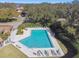 Community pool with lounge chairs and patio tables at 111 Woden Way, Winter Haven, FL 33884