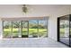 Spacious screened porch with tiled floor and view of backyard at 111 Woden Way, Winter Haven, FL 33884