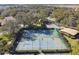 Two well-maintained tennis courts with surrounding fencing and landscaping at 111 Woden Way, Winter Haven, FL 33884