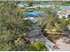 Home nestled amongst trees, near a lake at 1143 Waterview Pt, Lakeland, FL 33801